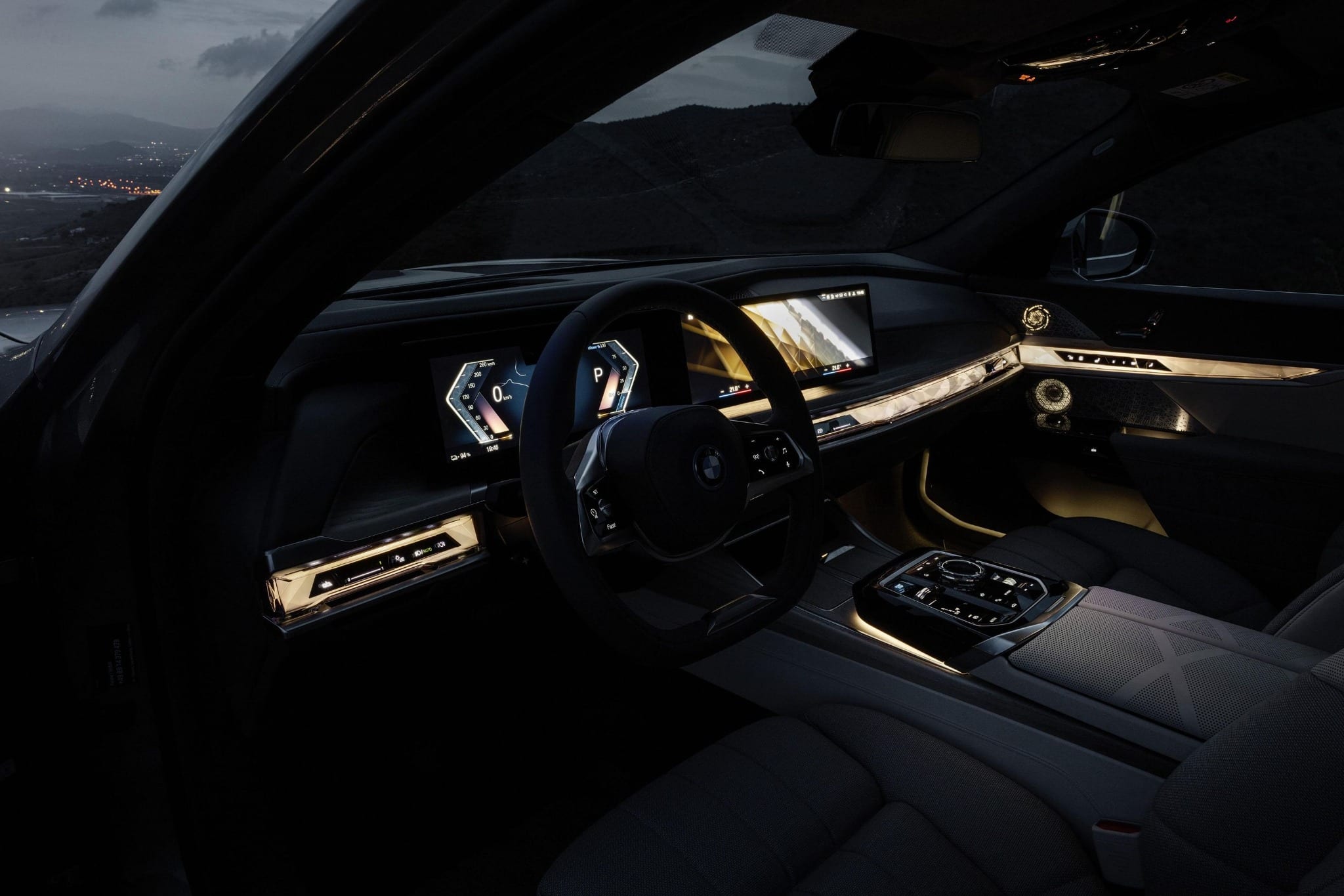 BMW 7 Series front cabin with illuminated dashboard and interior trim.