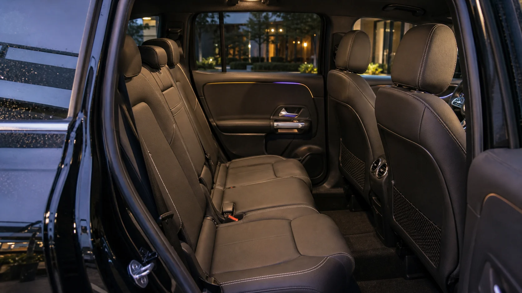 The clean black rear passenger cabin of a Mercedes-Benz EQB.